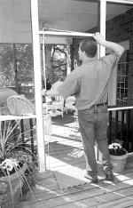 Man measuring screen door